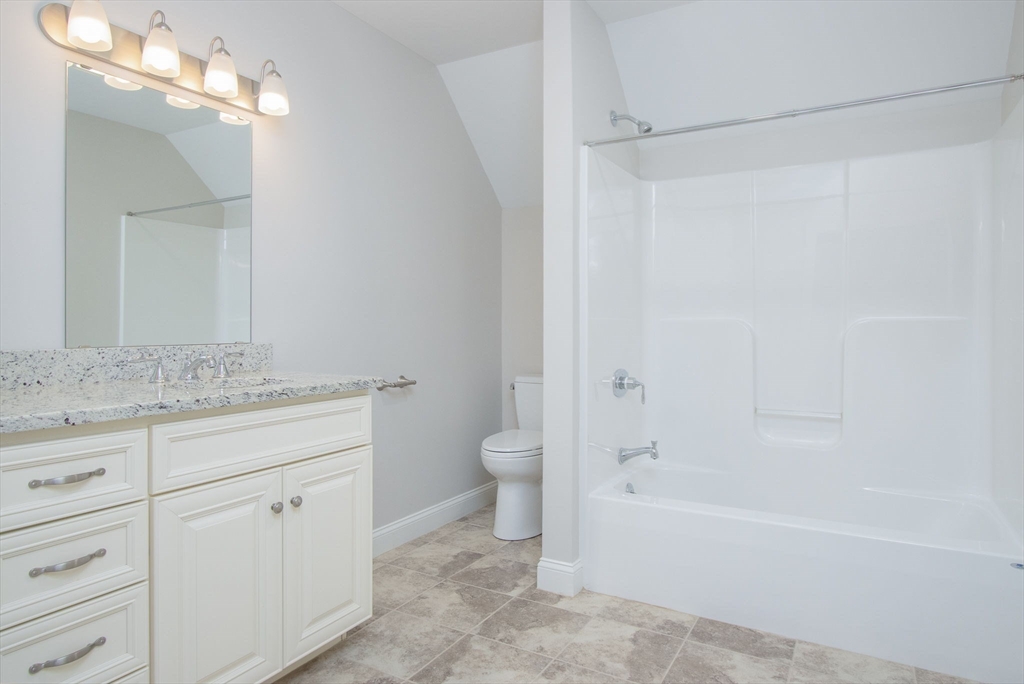 21 A Blacksmith Row, Unit 21 Groton, MA 01450 - Photo 26 of 42 a bathroom with a granite countertop sink a toilet and shower
