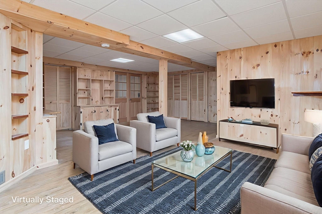 21 A Blacksmith Row, Unit 21 Groton, MA 01450 - Photo 28 of 42 a living room with furniture and a flat screen tv