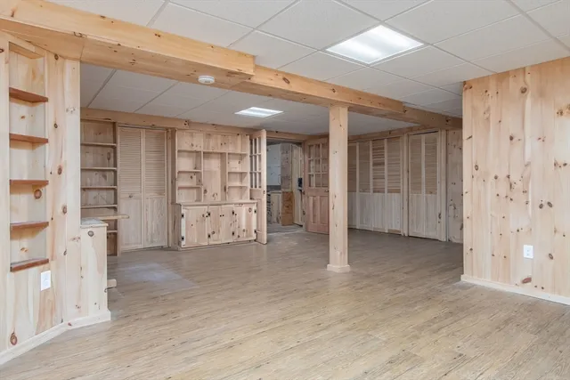 a view of empty room with wooden shelves and empty shelves
