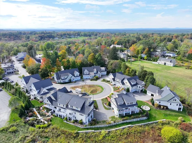 an aerial view of a house with a garden and lake view