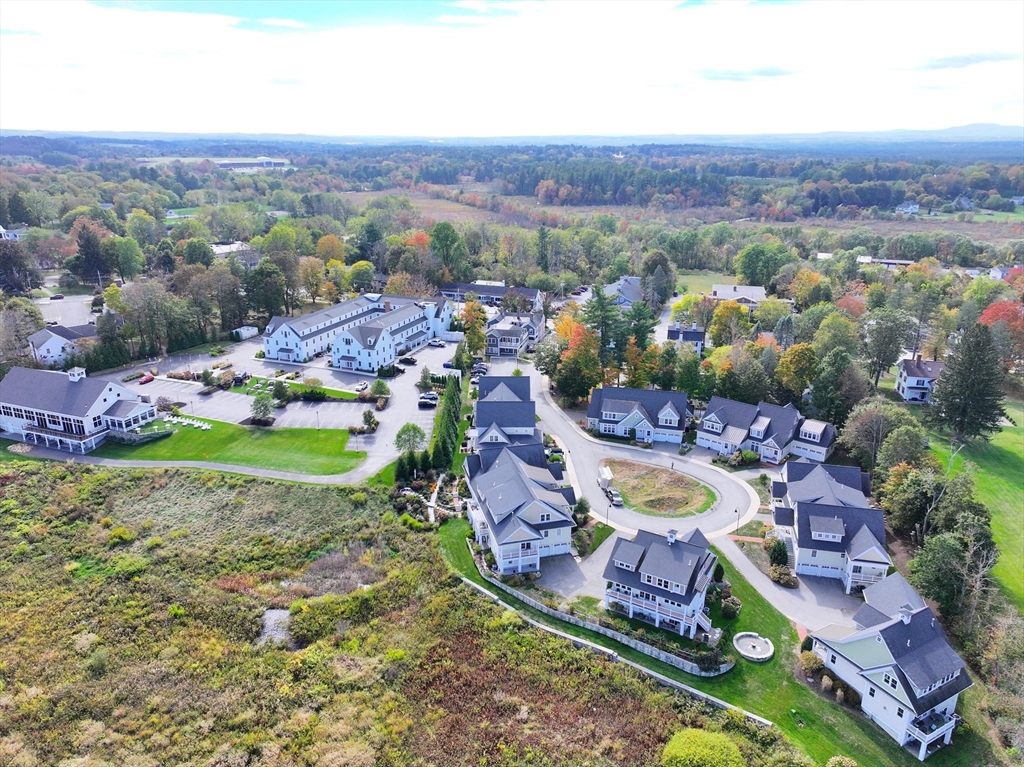 21 A Blacksmith Row, Unit 21 Groton, MA 01450 - Photo 35 of 42 an aerial view of a swimming pool yard and mountain view in back