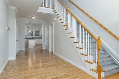 a view of entryway and hall with wooden floor