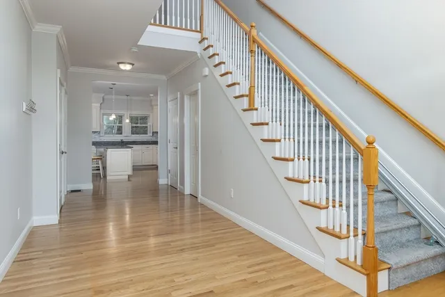 a view of entryway and hall with wooden floor