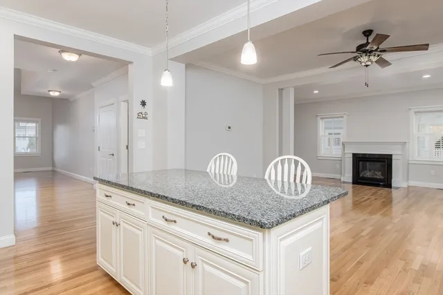 a kitchen with granite countertop a sink cabinets and stainless steel appliances
