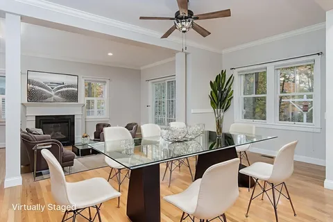 a dining room with furniture a floor to ceiling window and fireplace