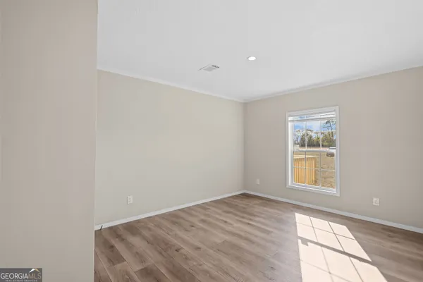 a view of an empty room and wooden floor