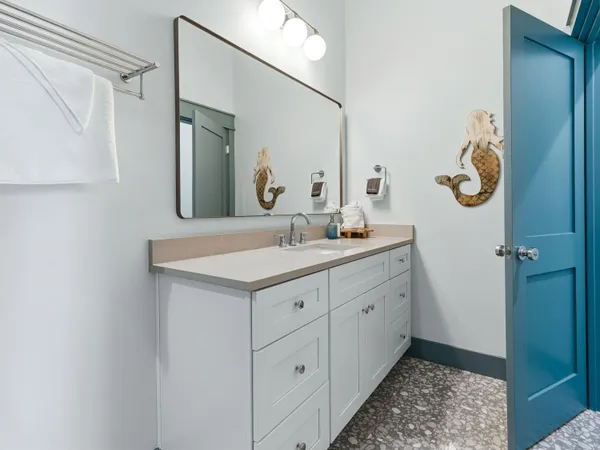 a bathroom with a granite countertop toilet sink and shower