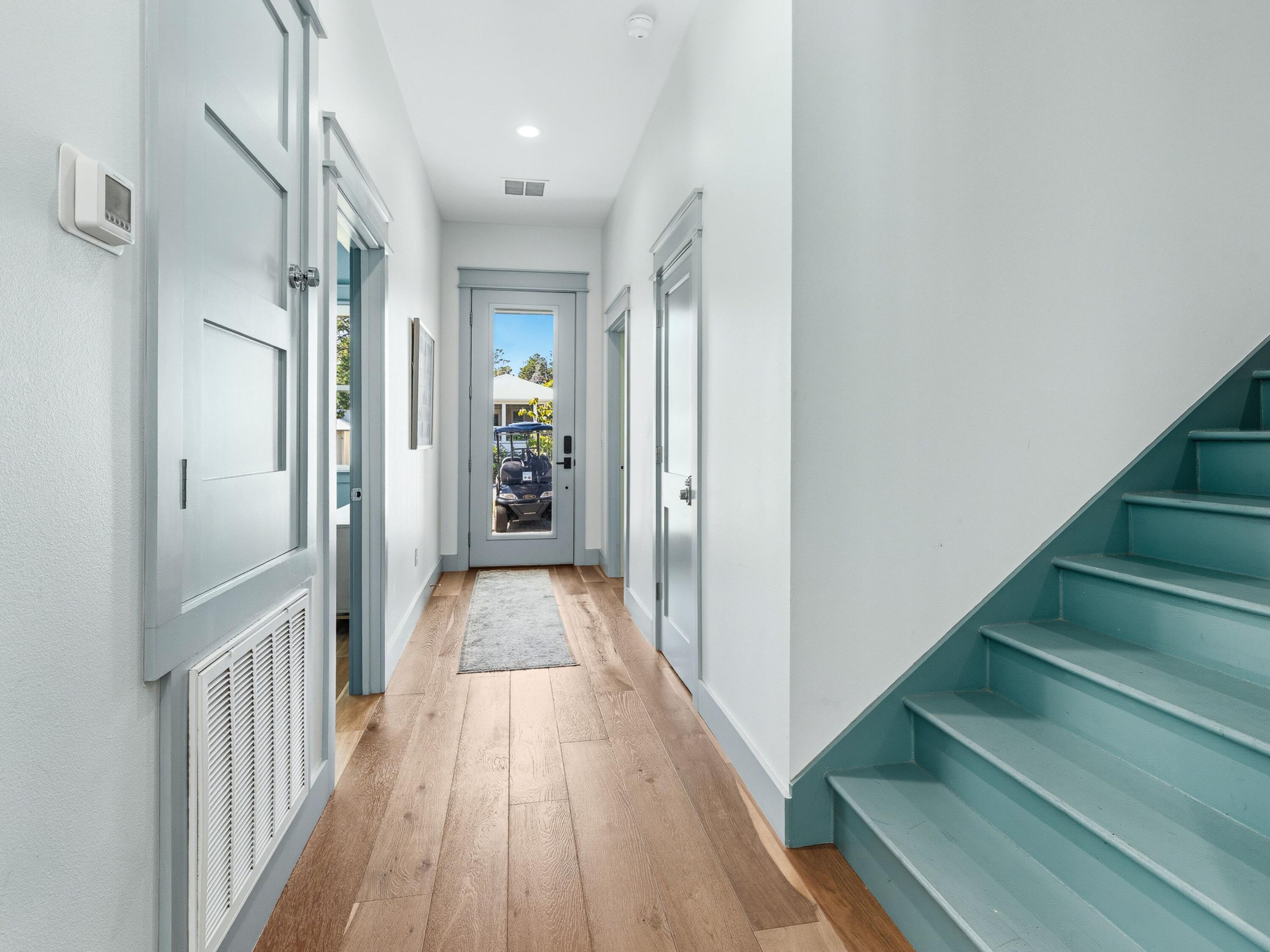 183 Walnut Street Santa Rosa Beach, FL 32459 - Photo 20 of 71 a view of a hallway with wooden floor and entryway