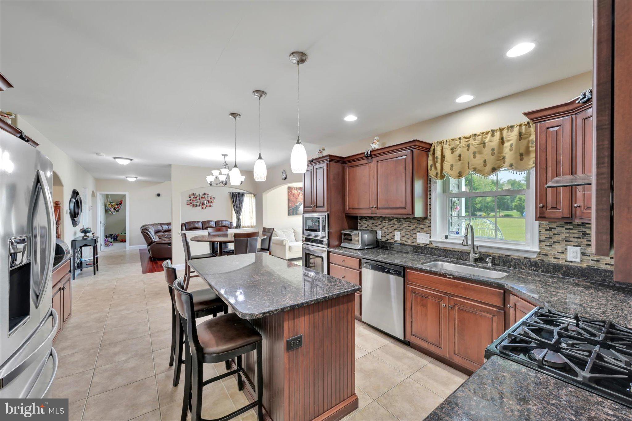 118 Connecticut Avenue Sinking Spring, PA 19608 - Photo 18 of 61 a kitchen with granite countertop a sink stove and cabinets