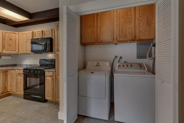 a kitchen with a refrigerator and a stove top oven