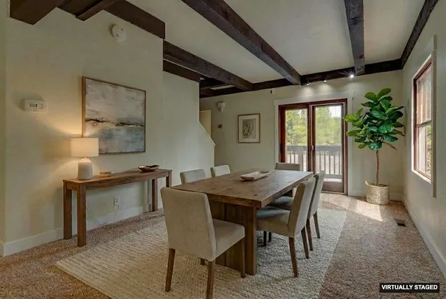 a view of a dining room with furniture and window