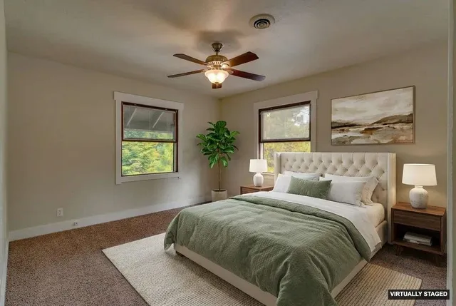 a bedroom with a bed and a painting on the wall