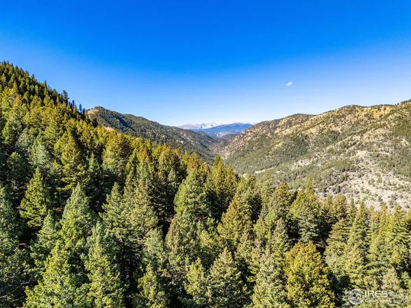 a view of a large building with mountains in the background