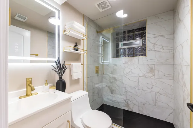 a bathroom with a sink toilet and shower