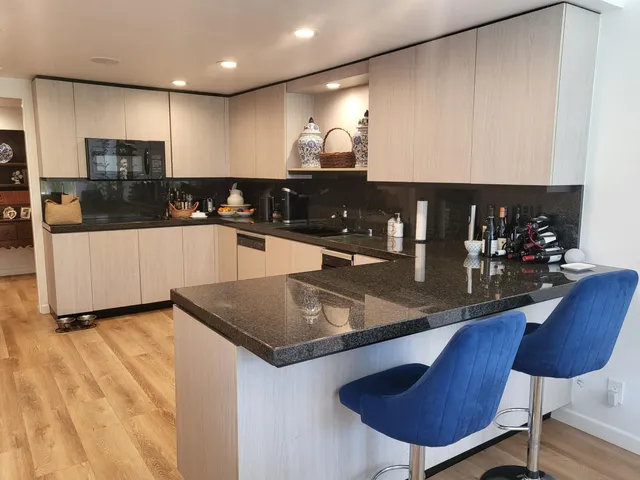 a kitchen with stainless steel appliances granite countertop a sink counter space and cabinets