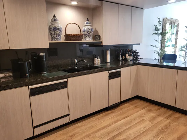 a kitchen with granite countertop a sink and cabinets