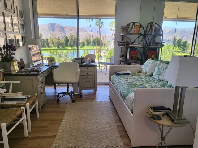 a living room with furniture and a floor to ceiling window