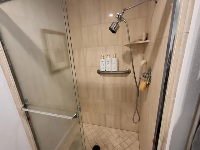 a bathroom with a shower and a shower