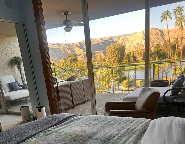 a bedroom with a bed and a large window