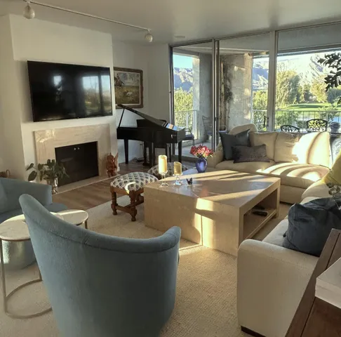 a living room with fireplace furniture and a flat screen tv