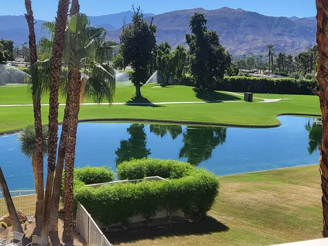 a view of a golf course with a lake view