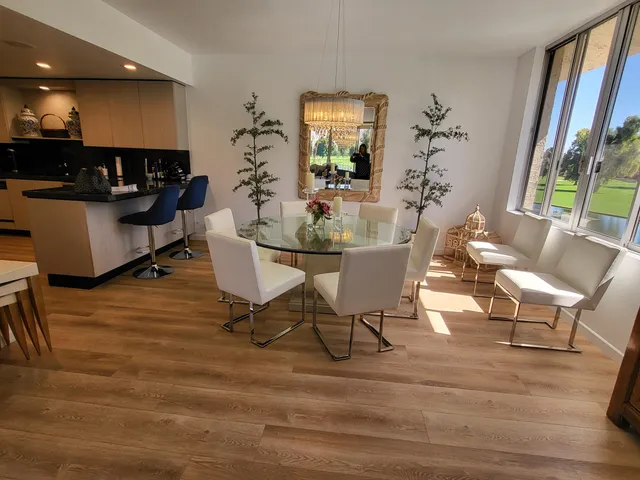 a dining room with furniture and wooden floor