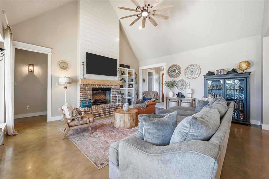 350 Rolling Rnch Boulevard Alvord, TX 76225 - Photo 18 of 30 a living room with furniture a flat screen tv and a fireplace
