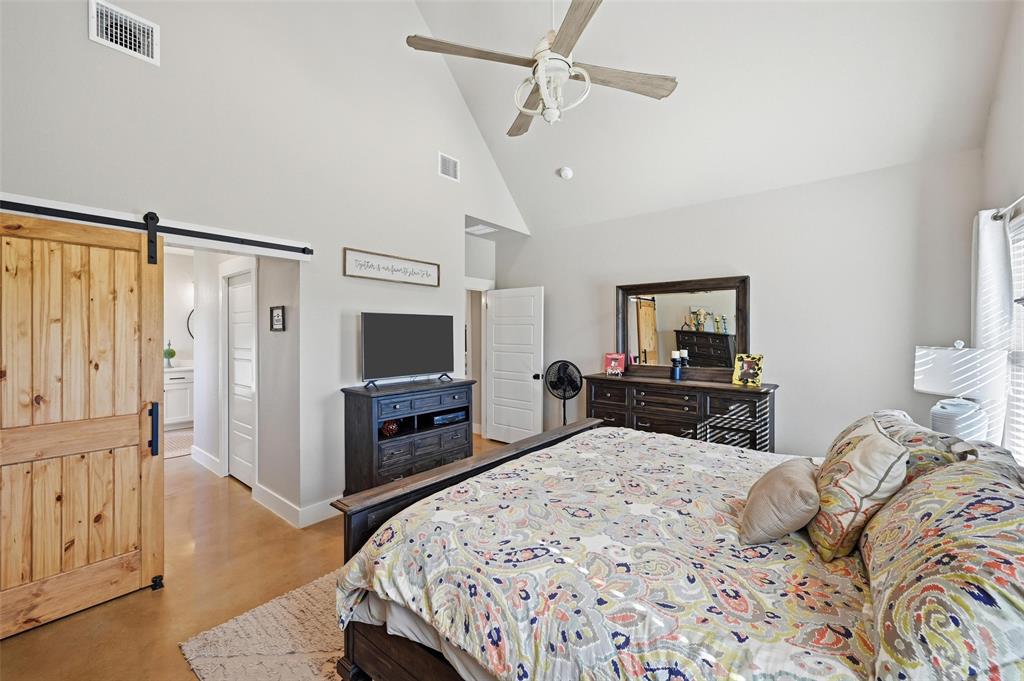 350 Rolling Rnch Boulevard Alvord, TX 76225 - Photo 23 of 30 a bedroom with a bed and a flat screen tv