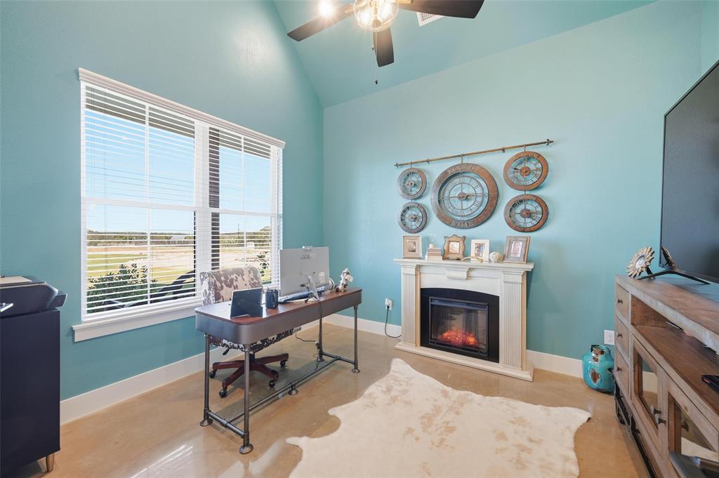 350 Rolling Rnch Boulevard Alvord, TX 76225 - Photo 24 of 30 a living room with furniture a window and a fireplace