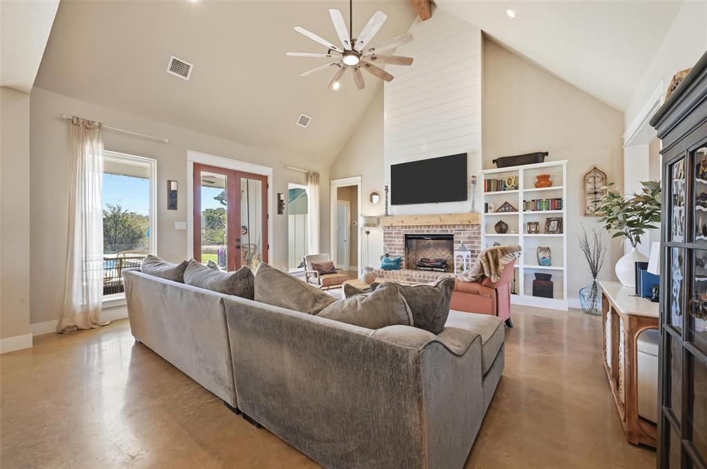 350 Rolling Rnch Boulevard Alvord, TX 76225 - Photo 7 of 30 a living room with furniture a fireplace and a flat screen tv