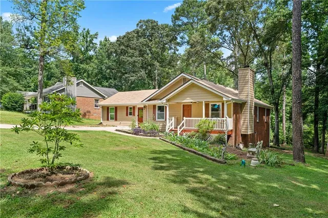 a front view of a house with yard and green space
