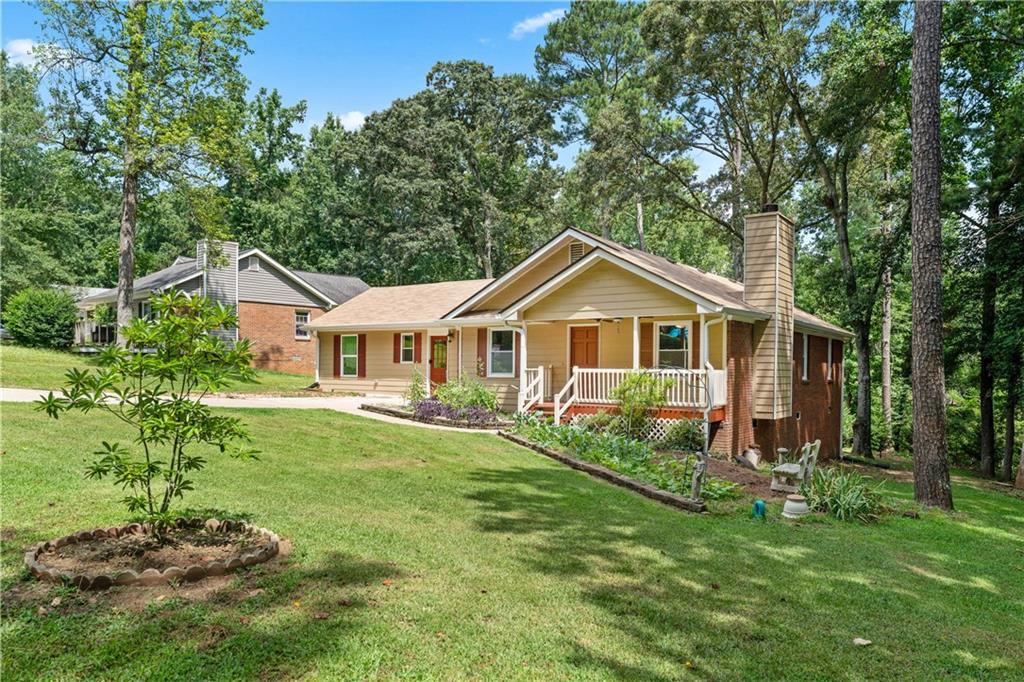 a front view of a house with yard and green space