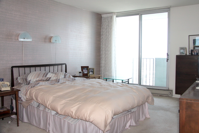 6033 North Sheridan Road, Unit 37K Chicago, IL 60660 - Photo 18 of 18 a bedroom with a large bed and a flat tv screen on dresser