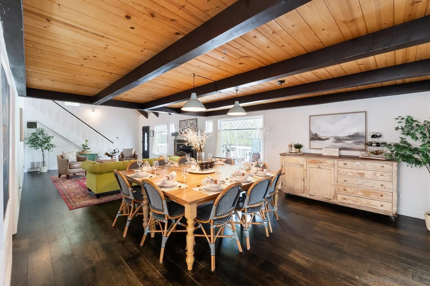 3517 Deer Lake Park Road Julian, CA 92036 - Photo 10 of 75 a dining room with furniture wooden floor a rug and a painting