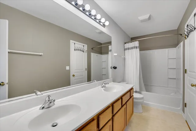 a bathroom with a tub sink double and mirror
