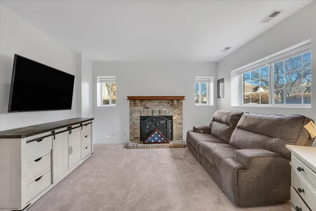 a living room with furniture fireplace and flat screen tv