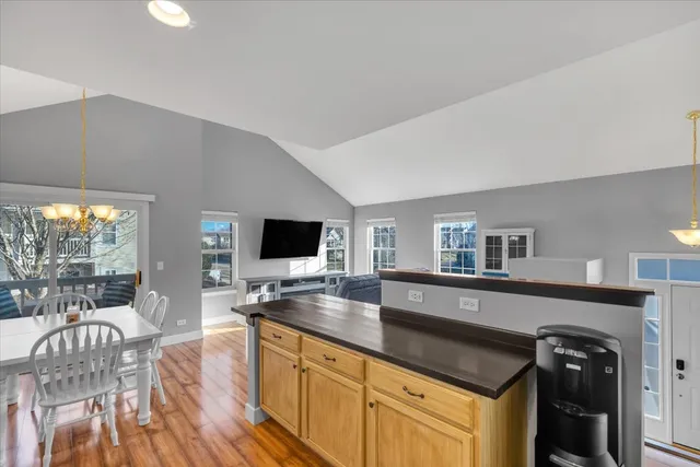 a kitchen with granite countertop a table and chairs in it