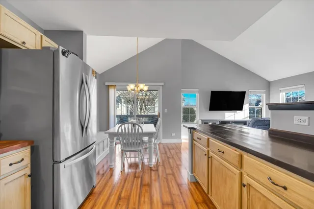 a kitchen with stainless steel appliances granite countertop a refrigerator and a sink