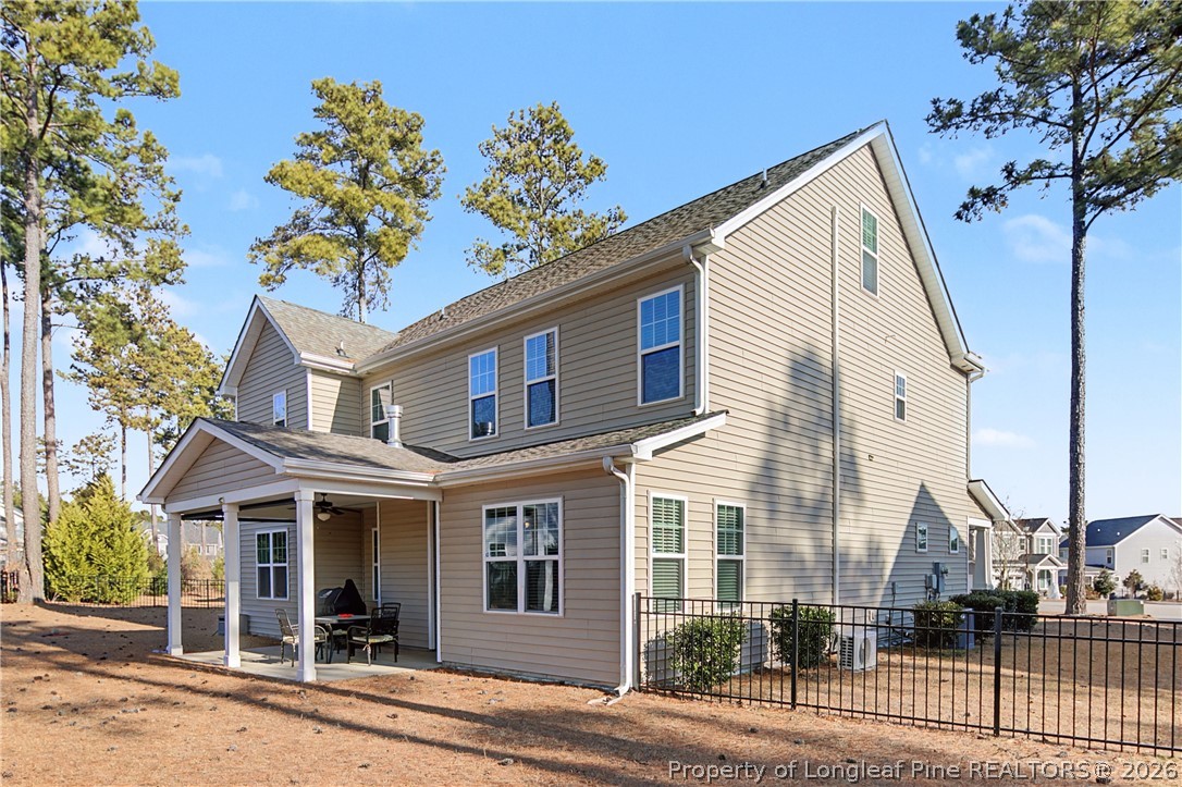 47 Pinnacle Drive Spring Lake, NC 28390 - Photo 40 of 50 a view of a white house with large windows and a tree