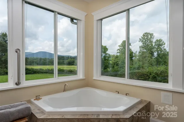 a bathroom with a tub and window