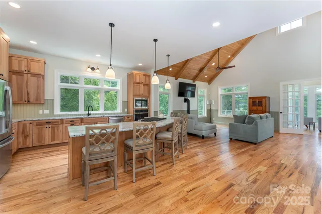 a large kitchen with a table and chairs