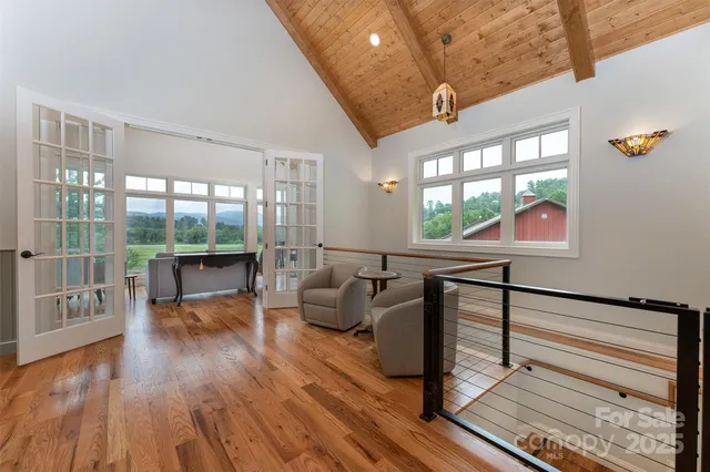 a very nice looking living room with a large window and wooden floor