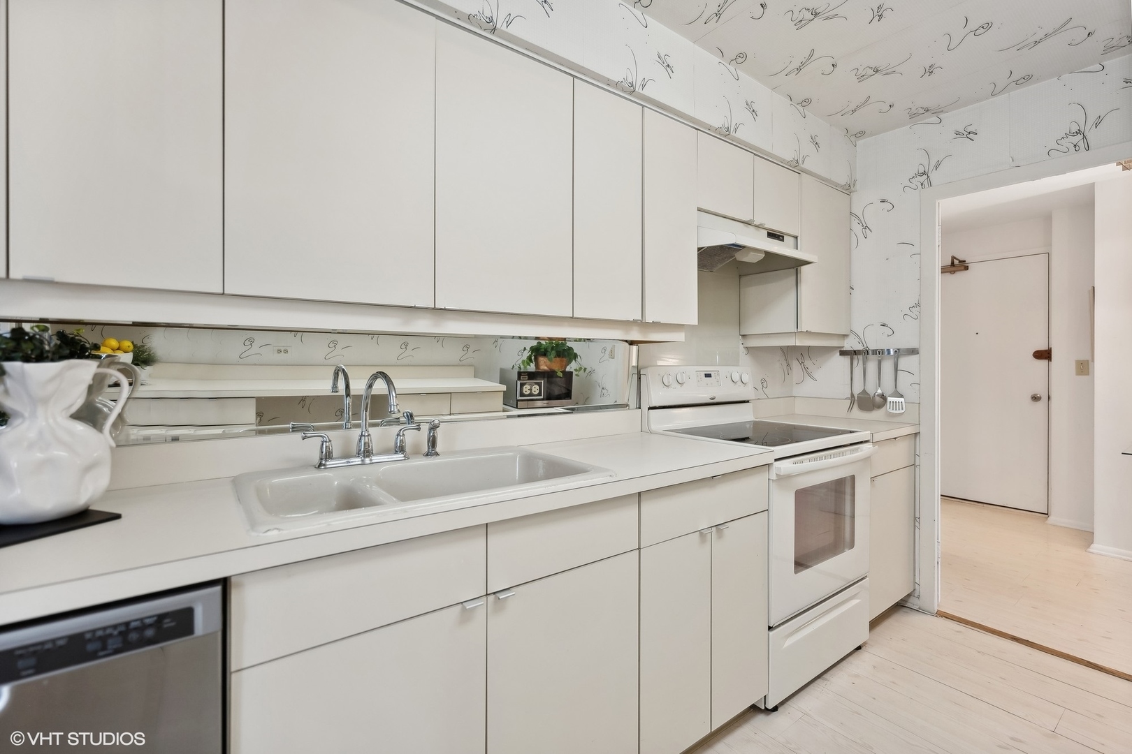 4250 North Marine Drive, Unit 2115 Chicago, IL 60613 - Photo 12 of 24 a kitchen with appliances cabinets and a sink