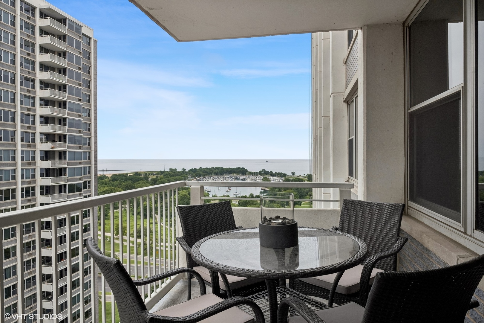 4250 North Marine Drive, Unit 2115 Chicago, IL 60613 - Photo 9 of 24 a view of a dining room with furniture window and wooden floor