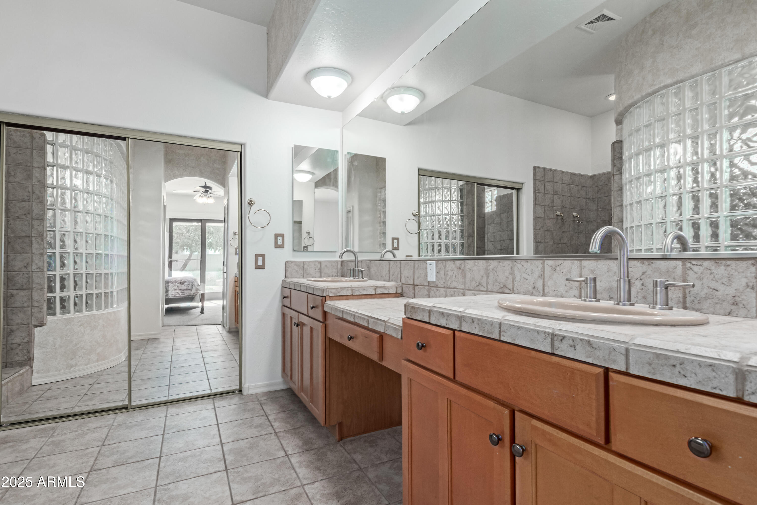 5752 South Crossbow Place Chandler, AZ 85249 - Photo 19 of 51 a large bathroom with a granite countertop sink mirror and