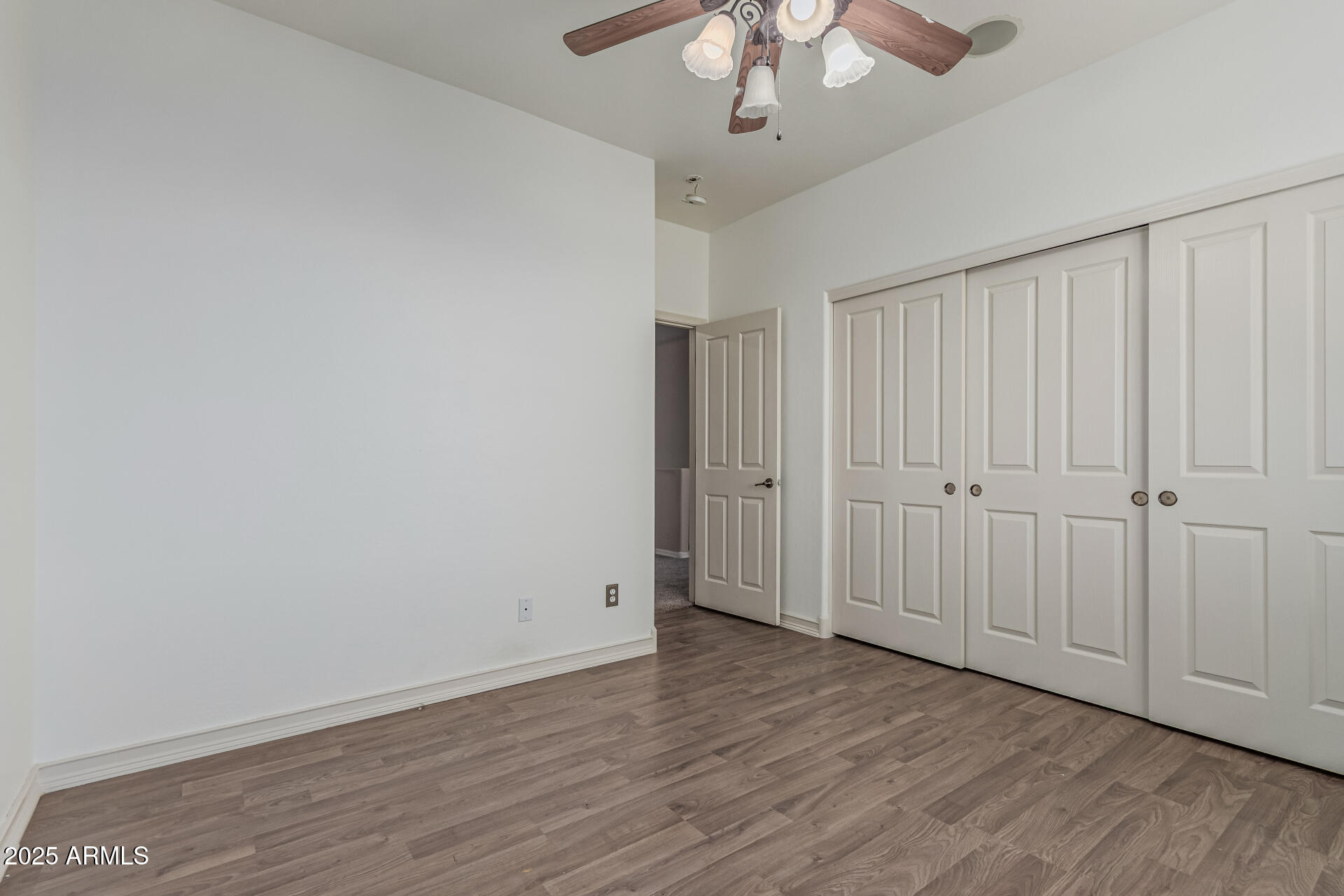 5752 South Crossbow Place Chandler, AZ 85249 - Photo 35 of 51 a view of an empty room with wooden floor