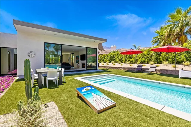 a view of a swimming pool with an outdoor space and seating area