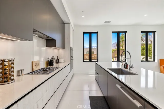 a kitchen with stainless steel appliances a sink a stove and a refrigerator