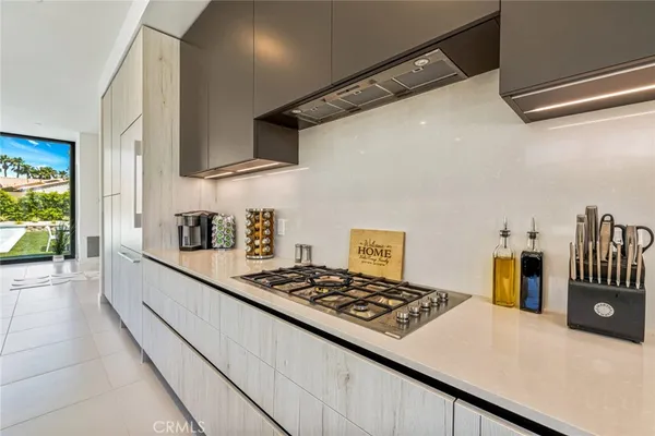 a kitchen with a table chairs stove and cabinets