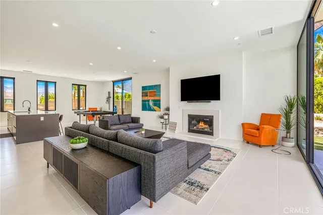 a living room with furniture wooden floor and a large window